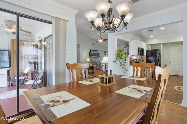 dining room with crown molding, ceiling fan with notable chandelier, and lofted ceiling