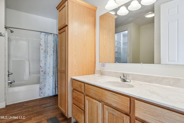 bathroom featuring vanity, hardwood / wood-style floors, and shower / bath combo with shower curtain