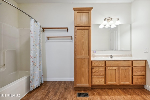 bathroom featuring vanity, wood-type flooring, and shower / bath combination with curtain