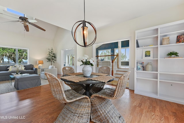 dining space featuring lofted ceiling, light hardwood / wood-style flooring, and ceiling fan