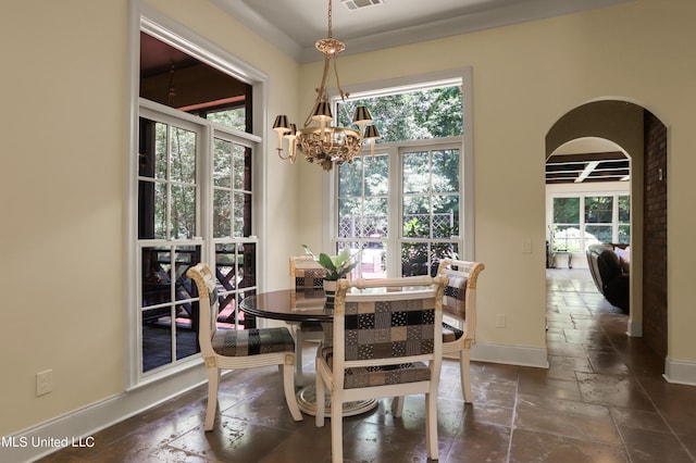 130 Bridgewater Xing, Ridgeland, MS 39157 - dining space with a chandelier, stone tile floors, arched walkways, and baseboards