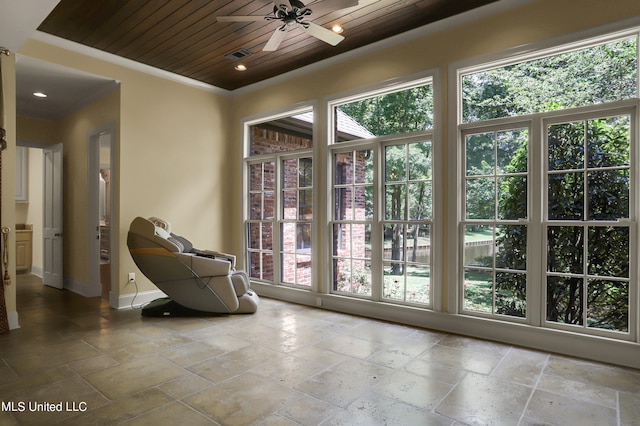 interior space featuring ceiling fan and wooden ceiling