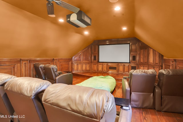 cinema room with lofted ceiling, wood-type flooring, and ceiling fan