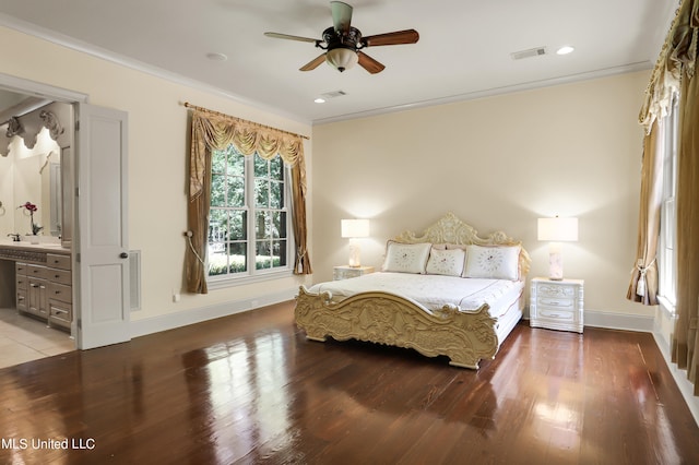 bedroom with ornamental molding, ensuite bathroom, wood-type flooring, and ceiling fan