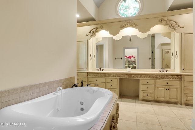 bathroom featuring vanity, a relaxing tiled tub, tile patterned floors, and vaulted ceiling