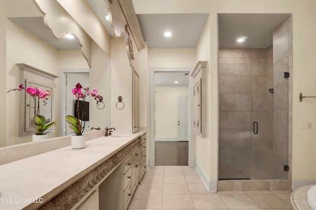 bathroom with vanity, walk in shower, and tile patterned flooring