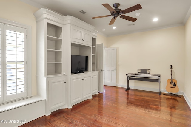 living room featuring crown molding, dark hardwood / wood-style floors, and ceiling fan