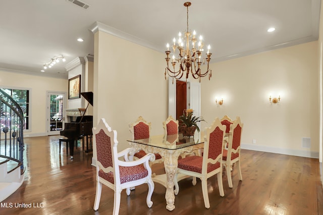 dining space with crown molding, dark hardwood / wood-style floors, and an inviting chandelier