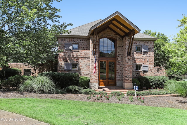 view of front of house featuring french doors and a front yard