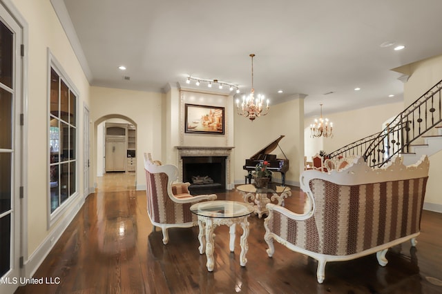 130 Bridgewater Xing, Ridgeland, MS 39157 - living area featuring a fireplace, arched walkways, wood finished floors, recessed lighting, and a chandelier