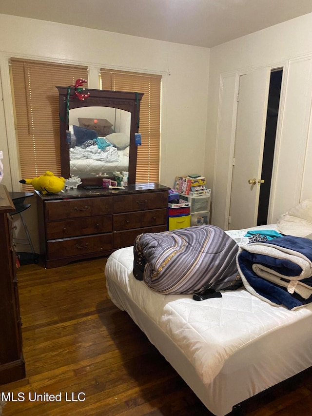 bedroom with dark hardwood / wood-style flooring