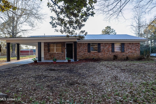 816 NE Boling St, Magee, MS 39111 - single story home featuring an attached carport, concrete driveway, brick siding, metal roof, and covered porch
