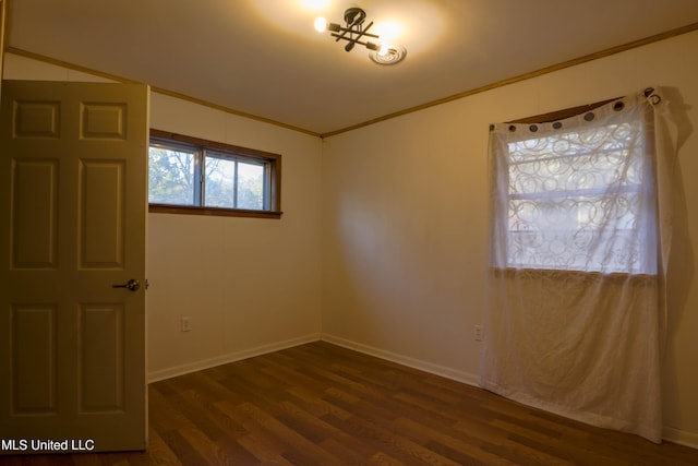 816 NE Boling St, Magee, MS 39111 - spare room with dark wood finished floors, ornamental molding, and baseboards