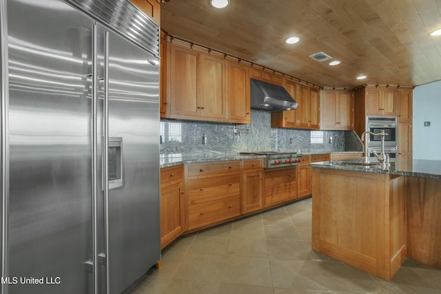 141 Janelle Dr, Bay Saint Louis, MS 39520 - kitchen with appliances with stainless steel finishes, extractor fan, a sink, light tile patterned flooring, and dark stone counters