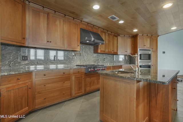 141 Janelle Dr, Bay Saint Louis, MS 39520 - kitchen featuring extractor fan, appliances with stainless steel finishes, recessed lighting, brown cabinetry, and a sink
