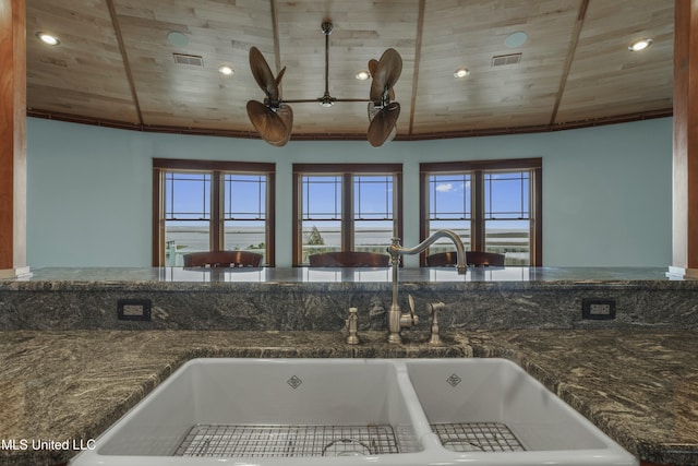 141 Janelle Dr, Bay Saint Louis, MS 39520 - kitchen view of a sink, wooden ceiling, recessed lighting, and dark stone counters