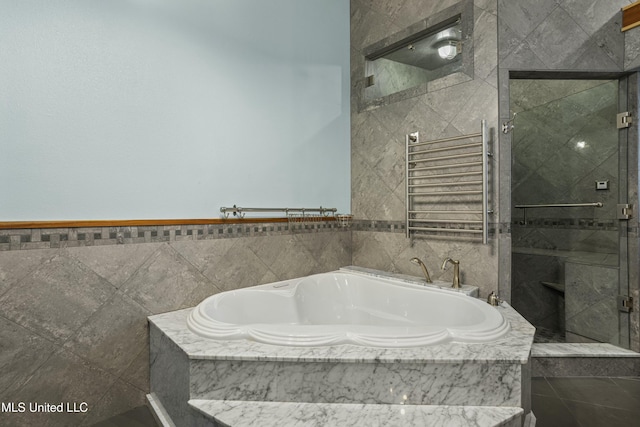 141 Janelle Dr, Bay Saint Louis, MS 39520 - full bathroom featuring radiator, a shower stall, a garden tub, and a towel warmer