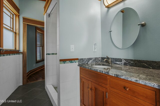 141 Janelle Dr, Bay Saint Louis, MS 39520 - full bathroom with tile walls, vanity, tile patterned flooring, a walk in shower, and healthy amount of natural light