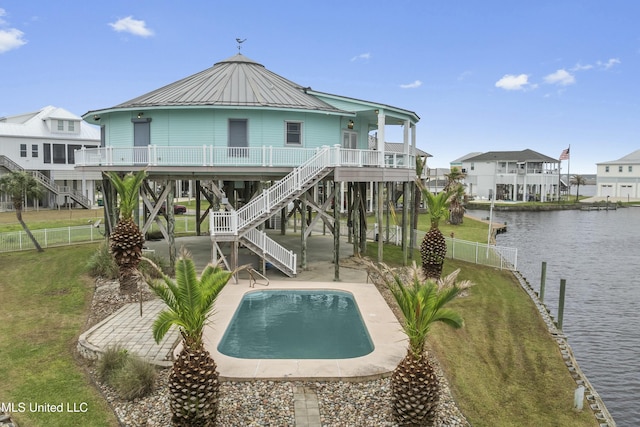 141 Janelle Dr, Bay Saint Louis, MS 39520 - rear view of property featuring stairs, a water view, an outdoor pool, a patio, and metal roof