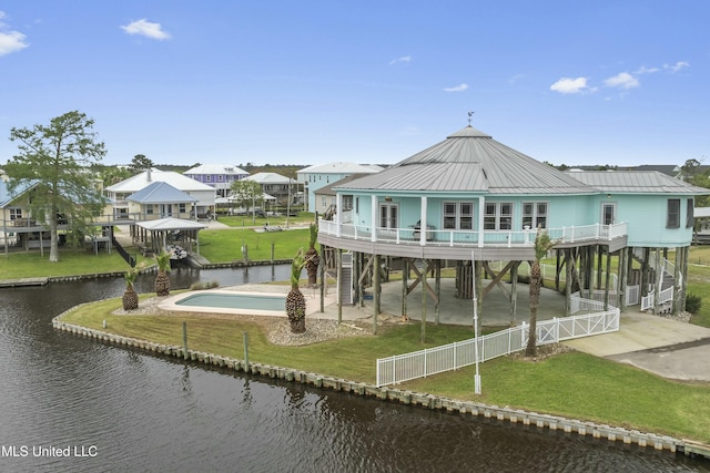 141 Janelle Dr, Bay Saint Louis, MS 39520 - rear view of property featuring a water view, a carport, stairway, driveway, and metal roof