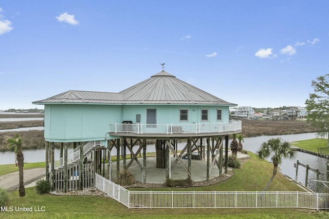 141 Janelle Dr, Bay Saint Louis, MS 39520 - back of house featuring a water view, a standing seam roof, metal roof, and a patio