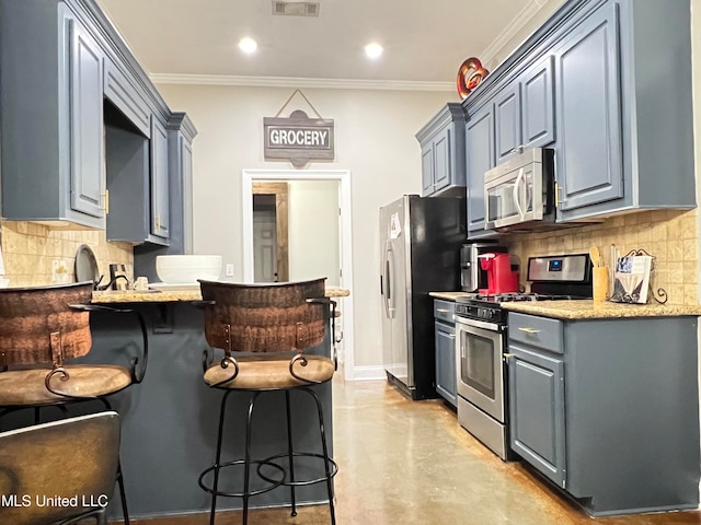 kitchen featuring decorative backsplash, appliances with stainless steel finishes, and crown molding