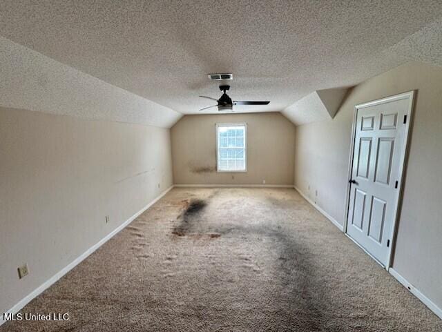 7428 Wallingford Dr, Olive Branch, MS 38654 - additional living space with lofted ceiling, carpet, ceiling fan, a textured ceiling, and baseboards