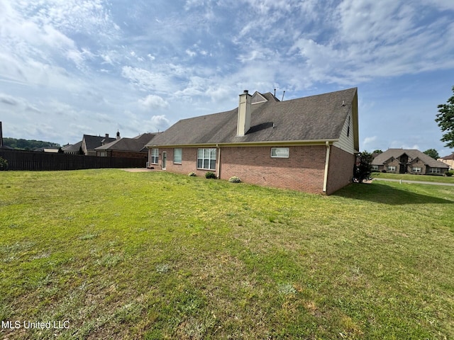 7428 Wallingford Dr, Olive Branch, MS 38654 - rear view of house featuring brick siding and a chimney