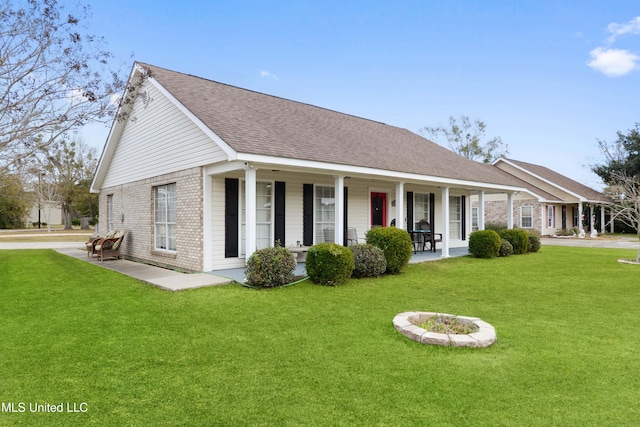 ranch-style house featuring a porch and a front yard