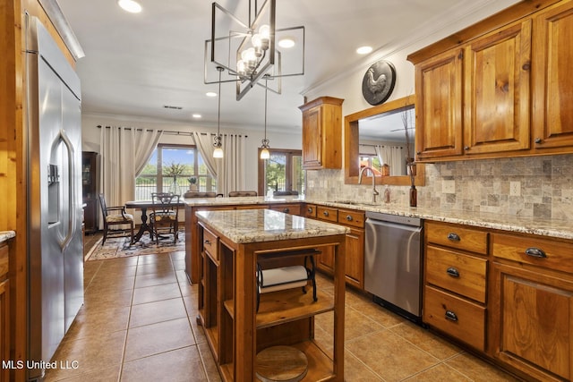 130 Pine Lake Cv, Flora, MS 39071 - kitchen with crown molding, appliances with stainless steel finishes, open shelves, brown cabinets, and a sink