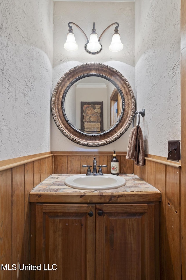 130 Pine Lake Cv, Flora, MS 39071 - bathroom featuring vanity, wood walls, a textured wall, and a wainscoted wall