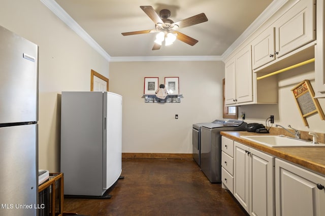 130 Pine Lake Cv, Flora, MS 39071 - laundry room with washer and dryer, cabinet space, ceiling fan, a sink, and ornamental molding