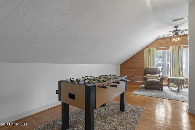 130 Pine Lake Cv, Flora, MS 39071 - rec room featuring visible vents, lofted ceiling, wooden walls, a textured ceiling, and a ceiling fan