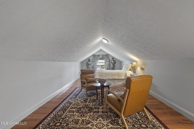 130 Pine Lake Cv, Flora, MS 39071 - living area featuring baseboards, a textured ceiling, lofted ceiling, and wood finished floors