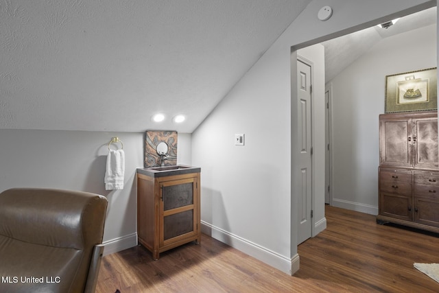 130 Pine Lake Cv, Flora, MS 39071 - living area featuring baseboards, vaulted ceiling, and wood finished floors