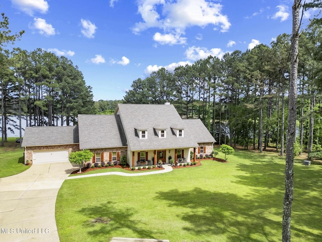 130 Pine Lake Cv, Flora, MS 39071 - view of front of house featuring a garage, driveway, and a front lawn