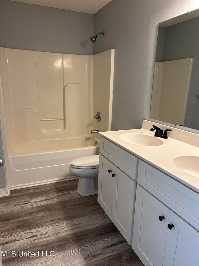 full bathroom featuring vanity, wood-type flooring, toilet, and shower / bathtub combination