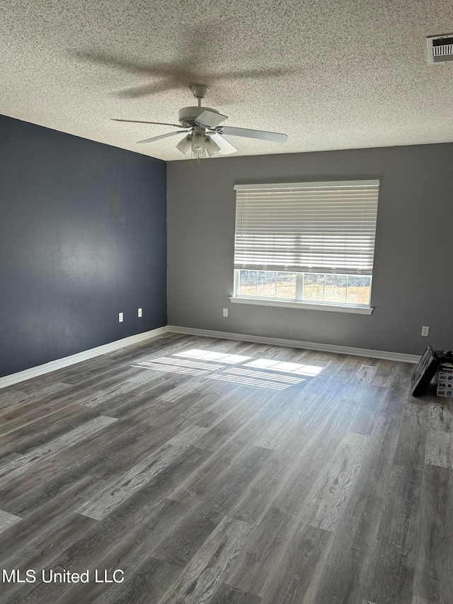 unfurnished room featuring a textured ceiling, ceiling fan, and dark hardwood / wood-style flooring