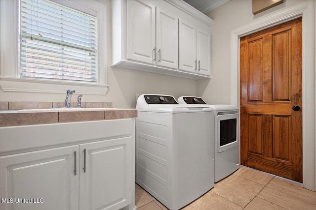 102 Hampton Chase, Madison, MS 39110 - laundry area with washing machine and clothes dryer, cabinet space, and light tile patterned flooring