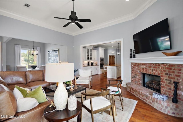 102 Hampton Chase, Madison, MS 39110 - living room with crown molding, a chandelier, wood finished floors, a fireplace, and a ceiling fan