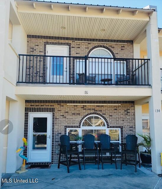 view of patio featuring a balcony