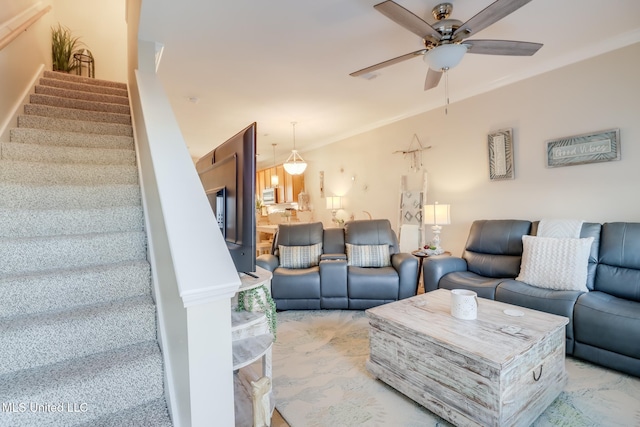 living room with ceiling fan and crown molding