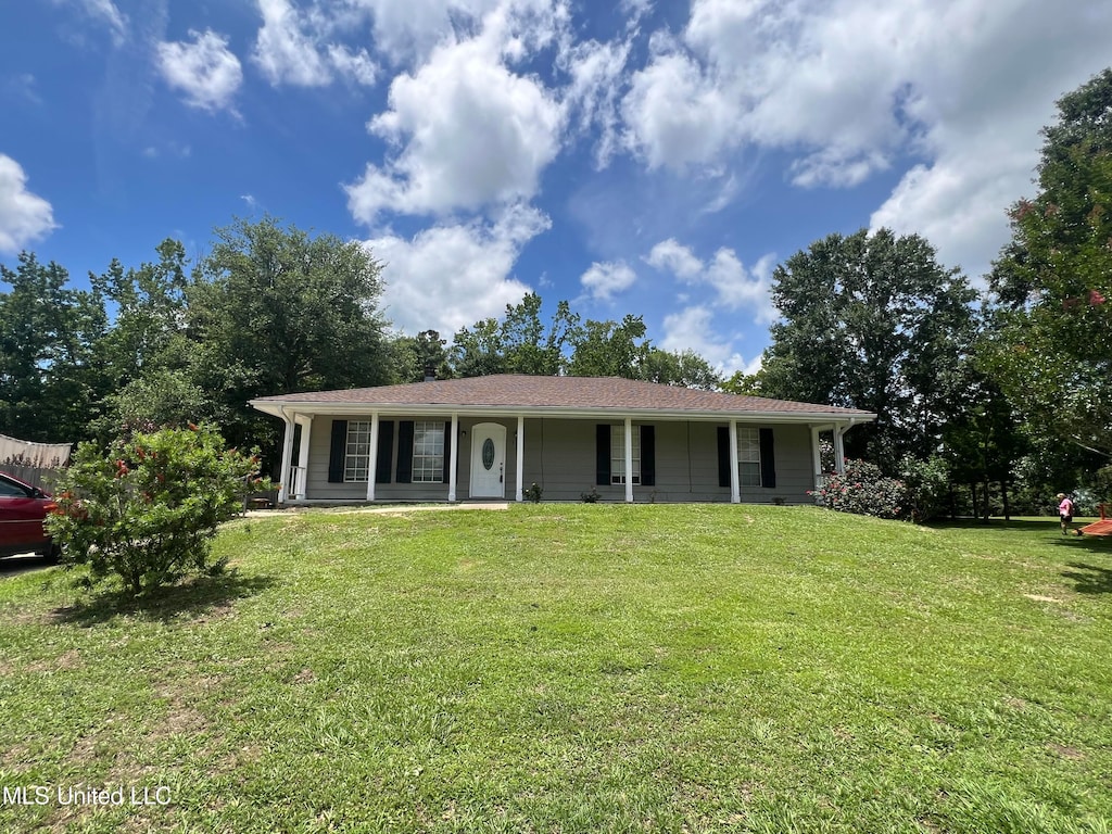 single story home with a front lawn and covered porch