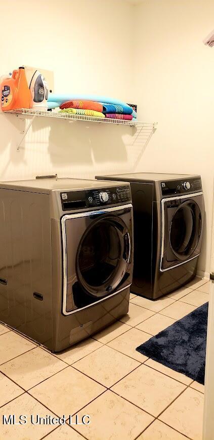 2252 Beach Dr Unit 701, Gulfport, MS 39507 - washroom with washing machine and dryer and light tile patterned floors