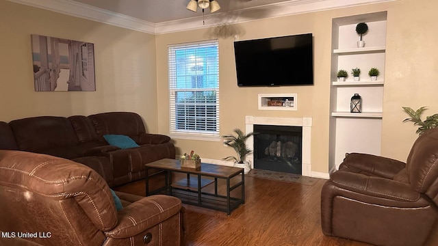 2252 Beach Dr Unit 701, Gulfport, MS 39507 - living area featuring wood finished floors, ornamental molding, built in shelves, a fireplace with flush hearth, and a ceiling fan