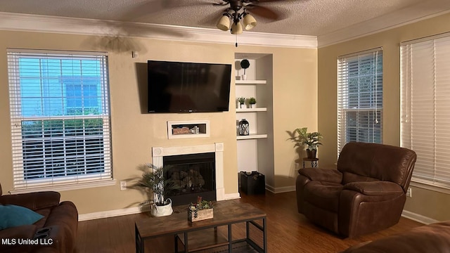 2252 Beach Dr Unit 701, Gulfport, MS 39507 - living area with wood finished floors, ornamental molding, ceiling fan, a textured ceiling, and a fireplace