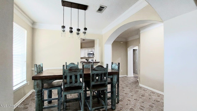 2252 Beach Dr Unit 701, Gulfport, MS 39507 - dining space featuring arched walkways and ornamental molding