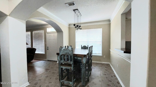 2252 Beach Dr Unit 701, Gulfport, MS 39507 - dining space with plenty of natural light, crown molding, tile patterned flooring, and arched walkways