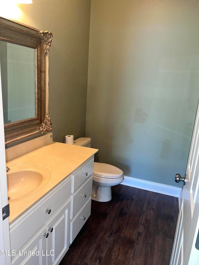 bathroom featuring vanity, hardwood / wood-style flooring, and toilet