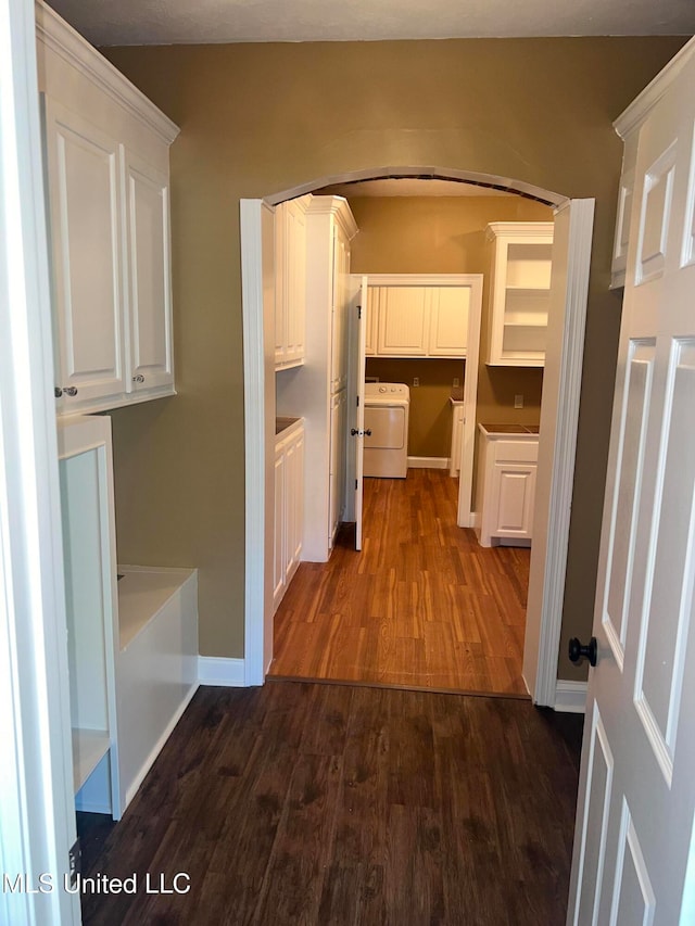 corridor with dark hardwood / wood-style flooring and washer / clothes dryer